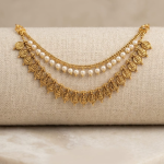 A two-layered drape design connected by structured gold-toned end-links